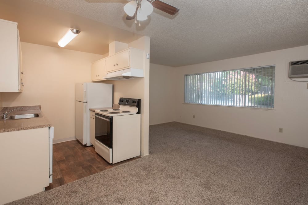 Kitchen and living room area at Coralaire Apartments in Sacramento, California
