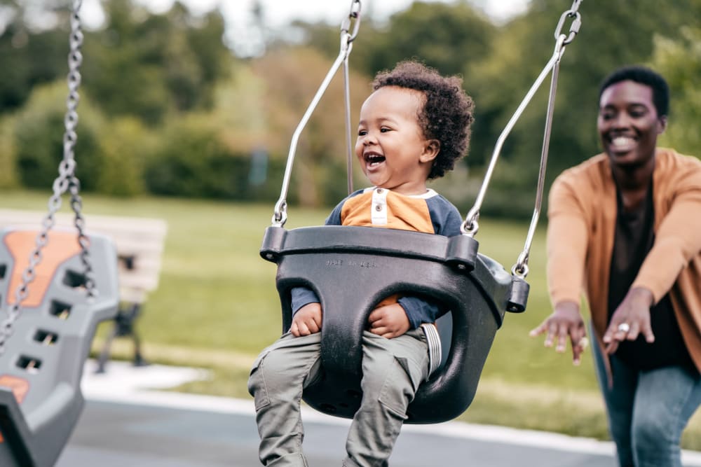 Residents playing on swing in park near Arden Palms Apartments in Sacramento, California