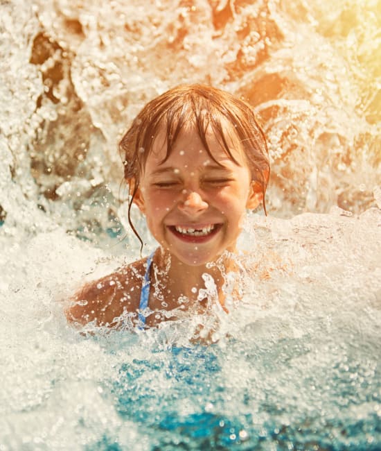 Resident swimming in pool of Auburn Townhomes in Auburn, California