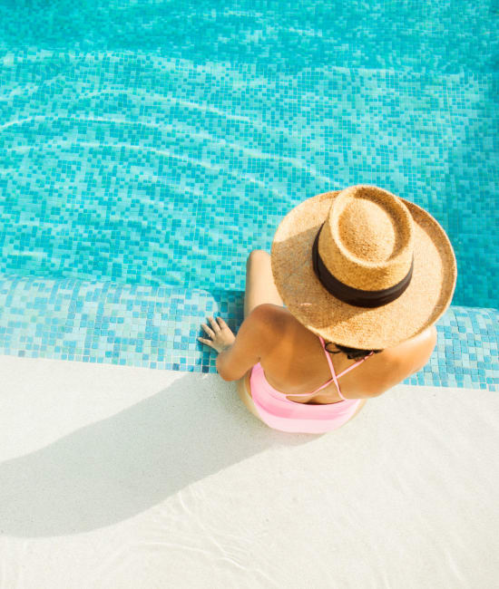 Resident swimming in pool of Arden Palms Apartments in Sacramento, California