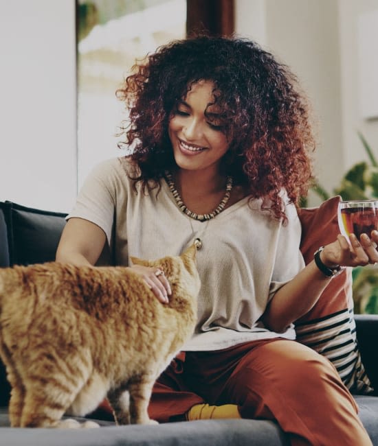 Resident petting cat at San Juan Hills in Fair Oaks, California